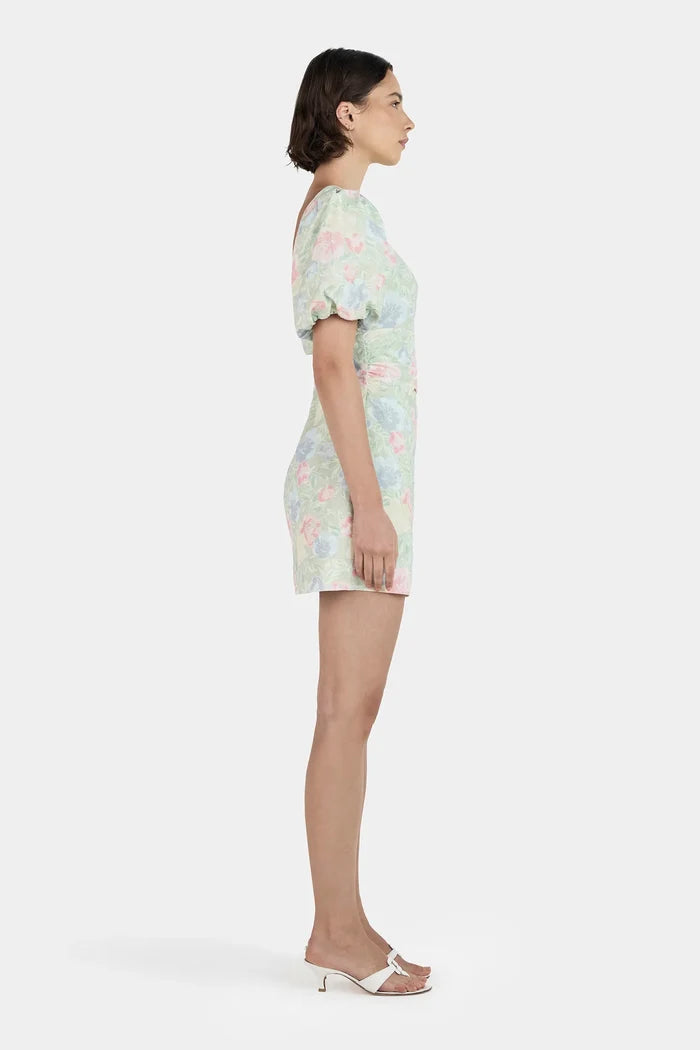 Woman wearing a green floral mini dress