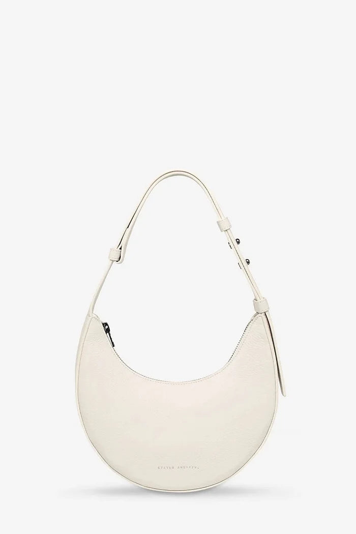 White handbag on a light beige background