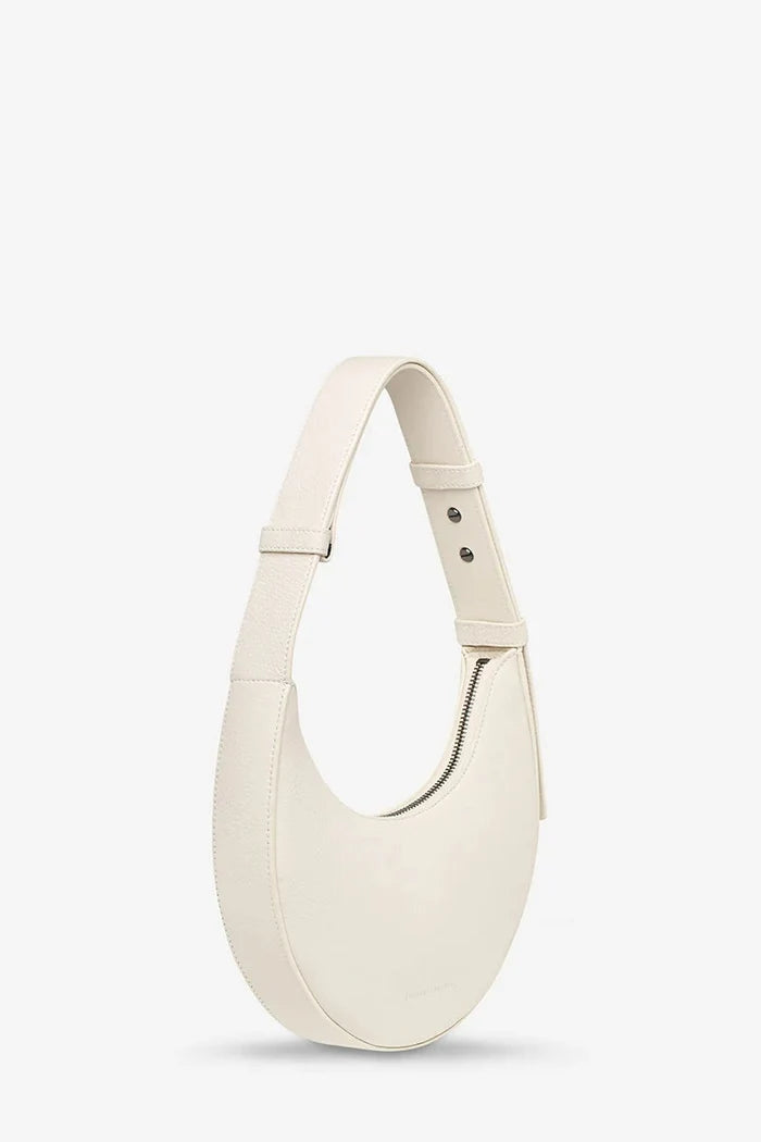 White handbag on a light gray background
