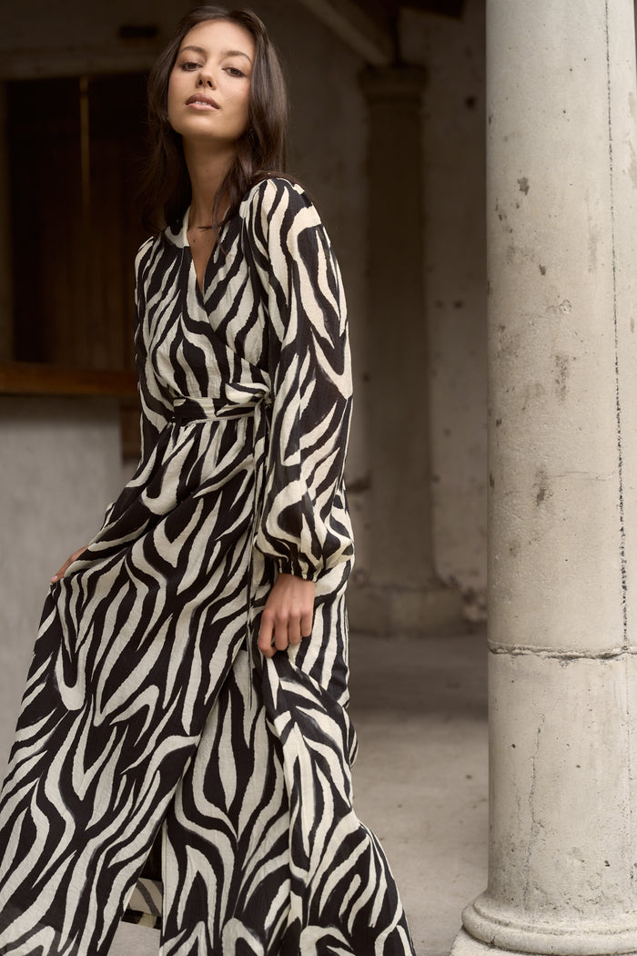 Model wears tiger print black and white wrap maxi long sleeve dress