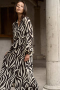 Model wears tiger print black and white wrap maxi long sleeve dress