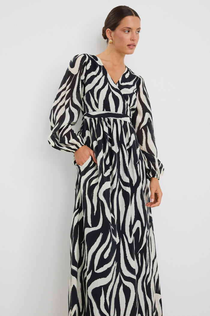 Model wears tiger print black and white wrap maxi long sleeve dress
