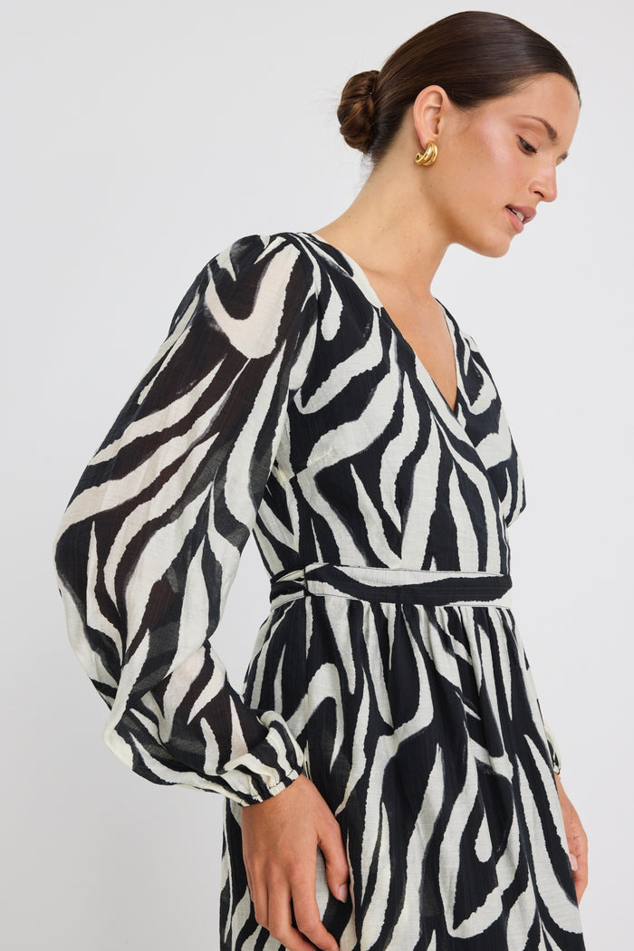 Model wears tiger print black and white wrap maxi long sleeve dress