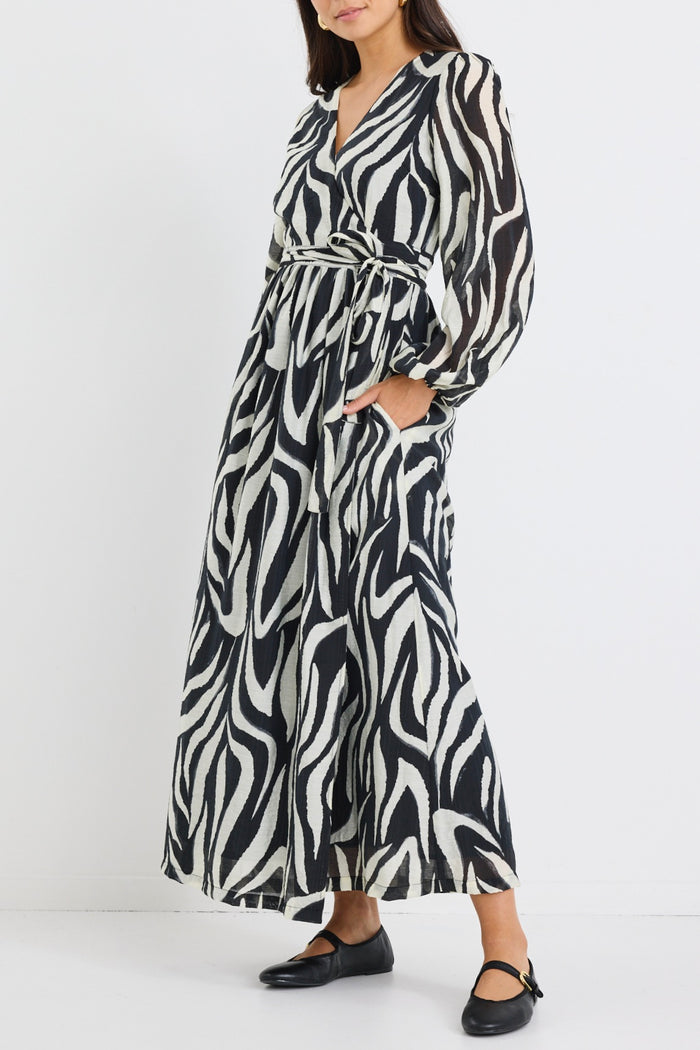 Model wears tiger print black and white wrap maxi long sleeve dress