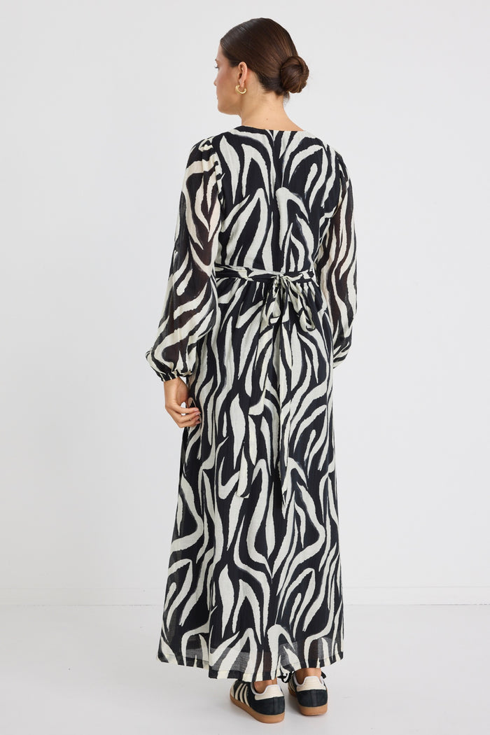 Model wears tiger print black and white wrap maxi long sleeve dress