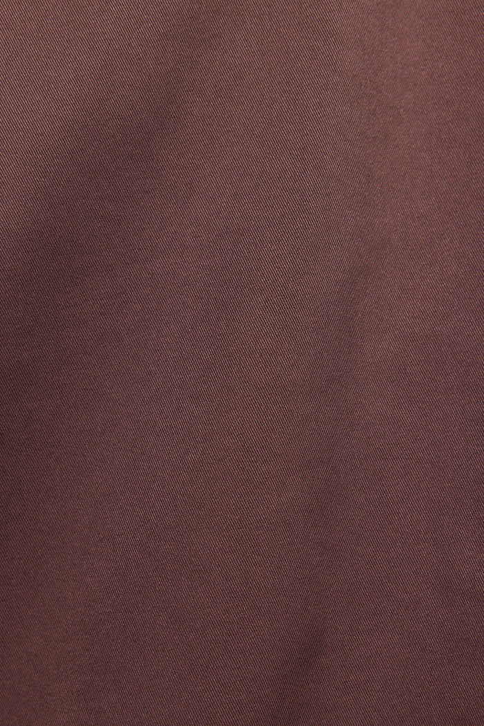 A close-up of a textured fabric in a muted, dusty rose-brown color.