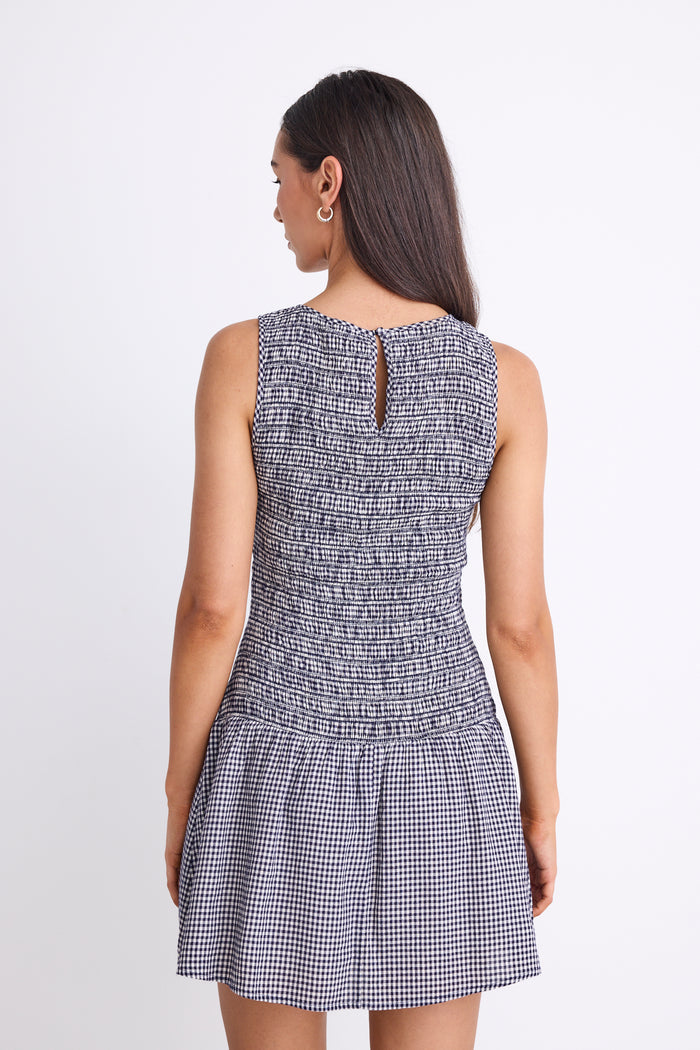 woman wearing navy gingham mini dress