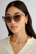 Transparent square cat-eye sunglasses with smoke gradient lenses.