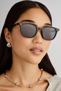 Black rounded sunglasses with smoke-tinted polarized lenses, shown front-facing on a white background.