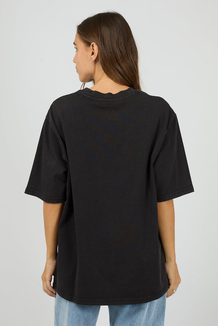 Person wearing a black t-shirt on a plain background