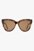 Front-facing view of oversized cat-eye sunglasses in a glossy tortoiseshell frame with warm brown lenses. The bold, sculpted silhouette adds a vintage-inspired edge with a modern twist.
