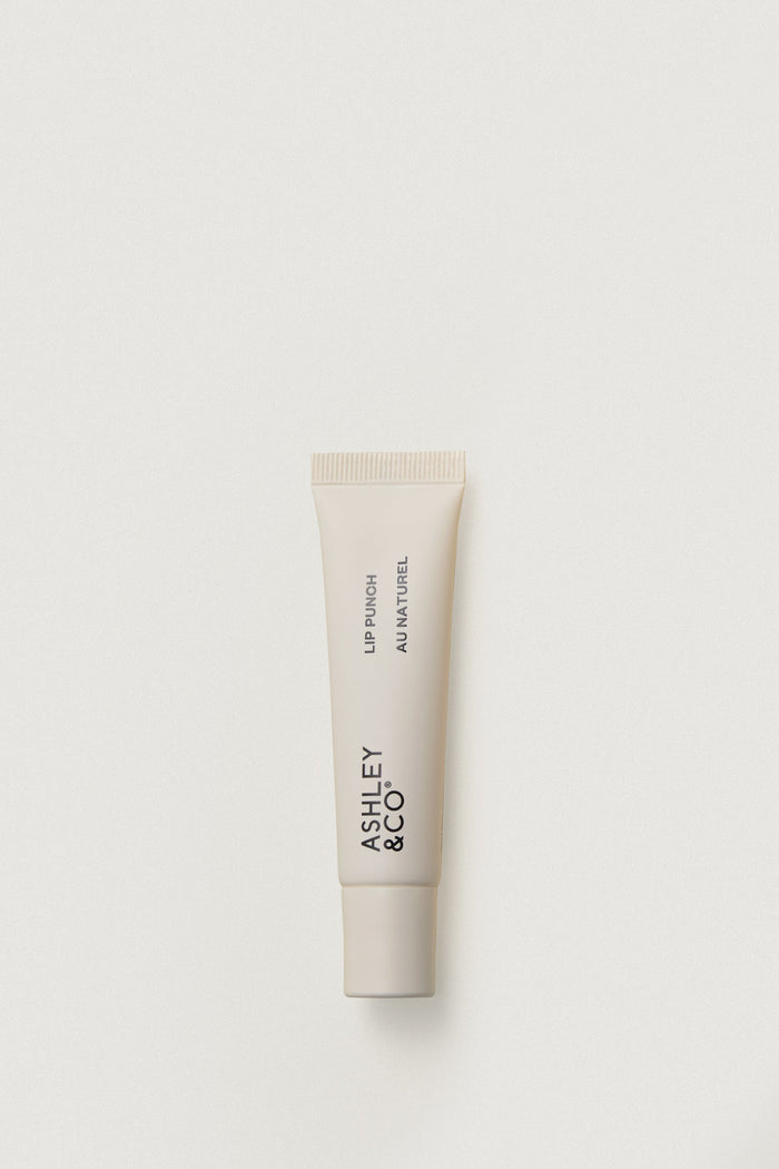 Lip balm tube with 'Ashley & Co' branding on a light gray background