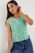 Woman wearing a sleeveless green and white striped shirred top with a peplum hem, styled with mid-blue denim jeans.