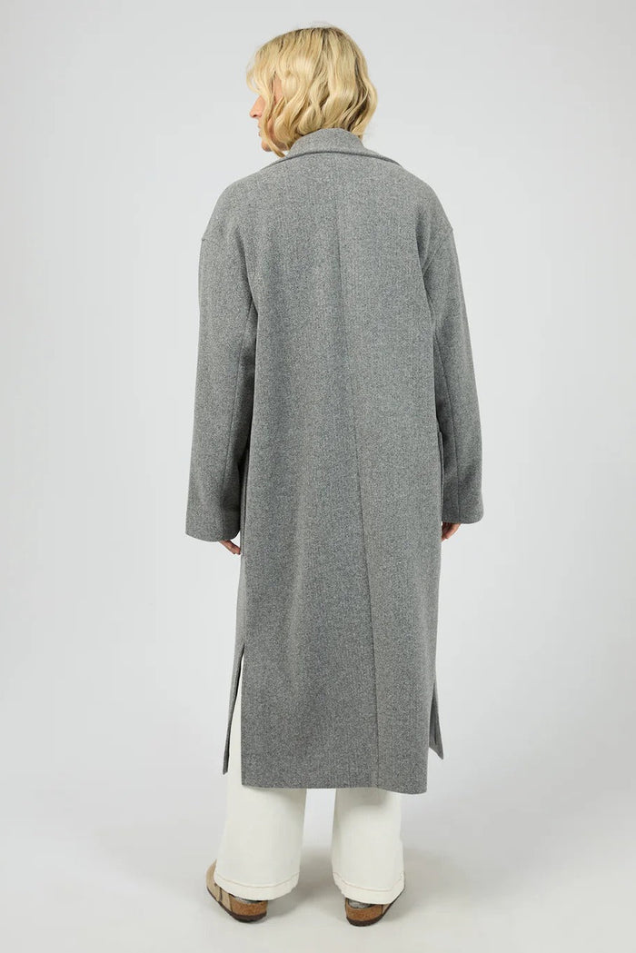 Person wearing a gray coat on a white background