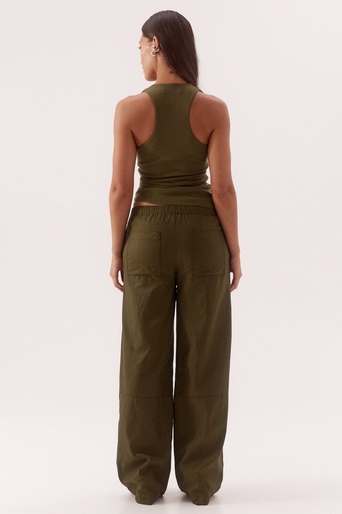 Person wearing a green jumpsuit on a white background