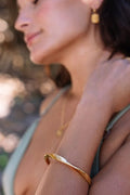 gold bangle on tan model