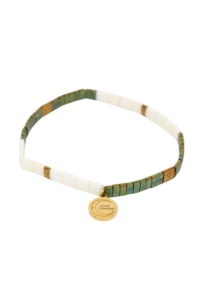 Necklace with green and gold accents on a white background
