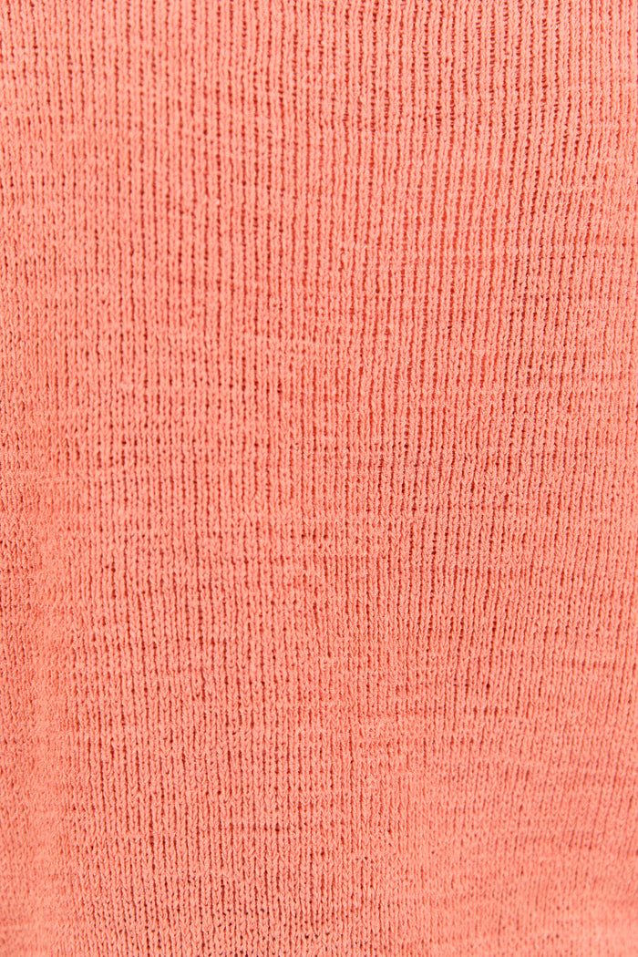 Close up of orange shirt knit material.