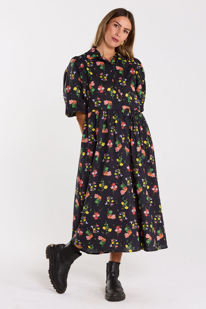 Woman wearing a floral dress on a white background