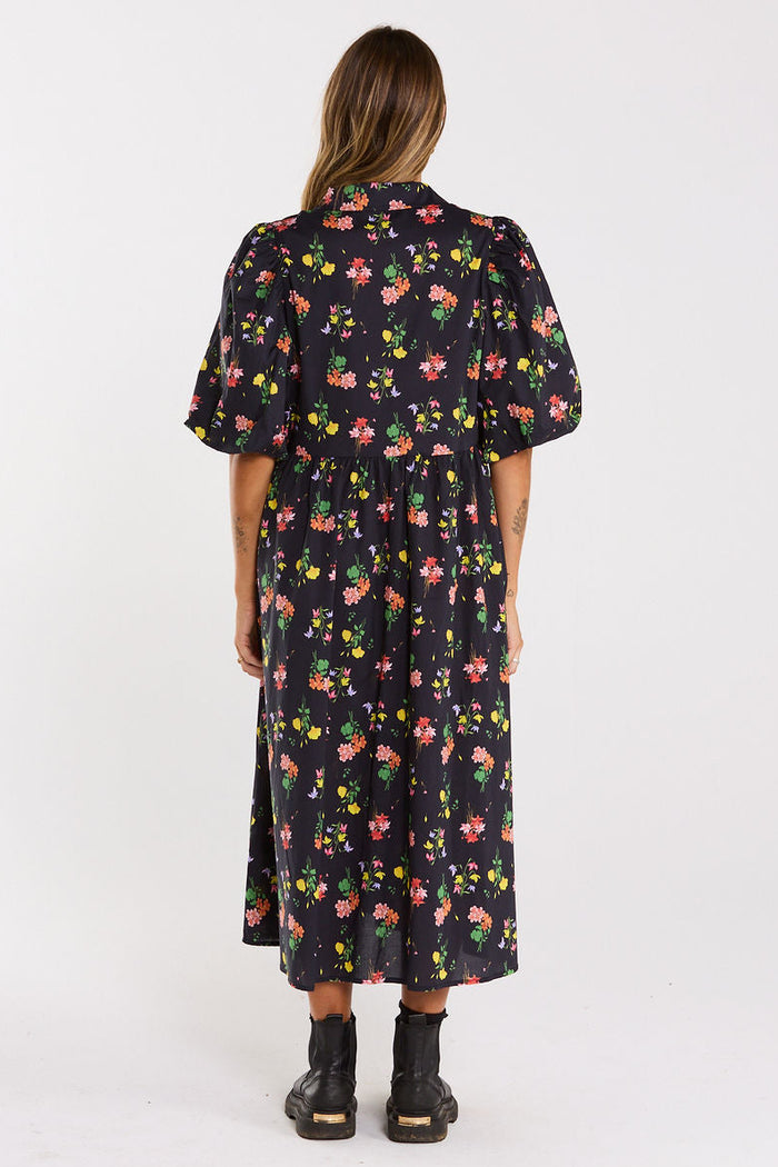 Woman wearing a floral dress on a white background