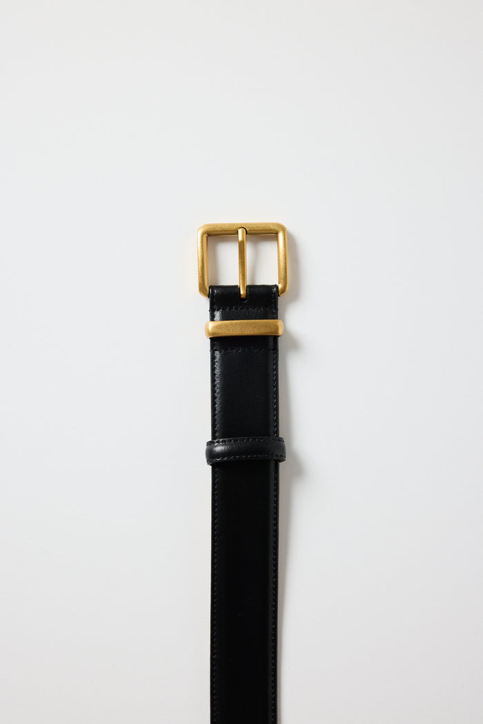 Black leather belt with a gold buckle on a white background
