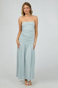 woman wears a blue ruched maxi dress