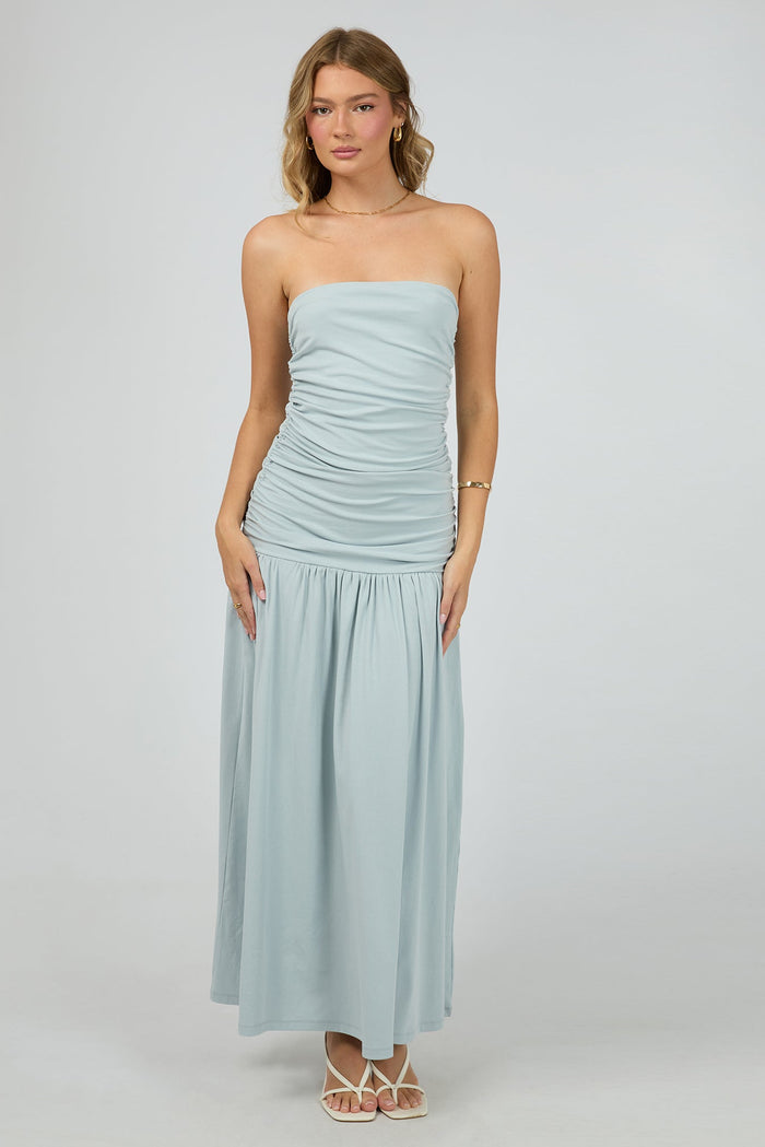 woman wears a blue ruched maxi dress