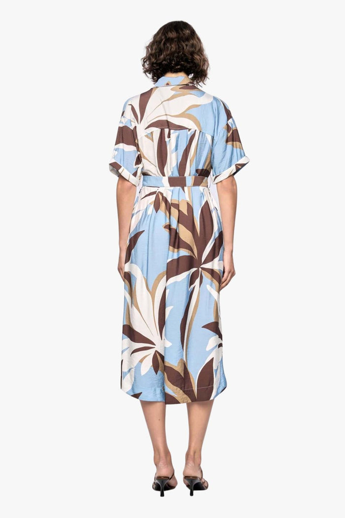 model wears a blue white brown pattern midi shirt dress