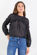 Women wearing black blouse with blue jeans.