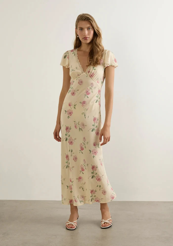 model wears a cream floral dress
