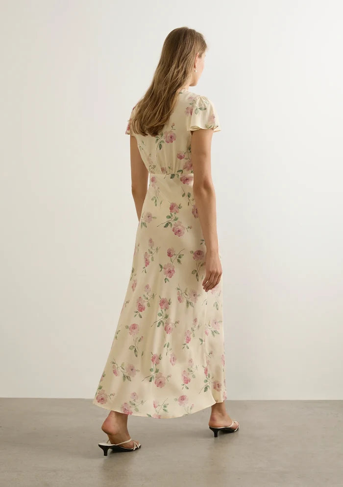 model wears a cream floral dress