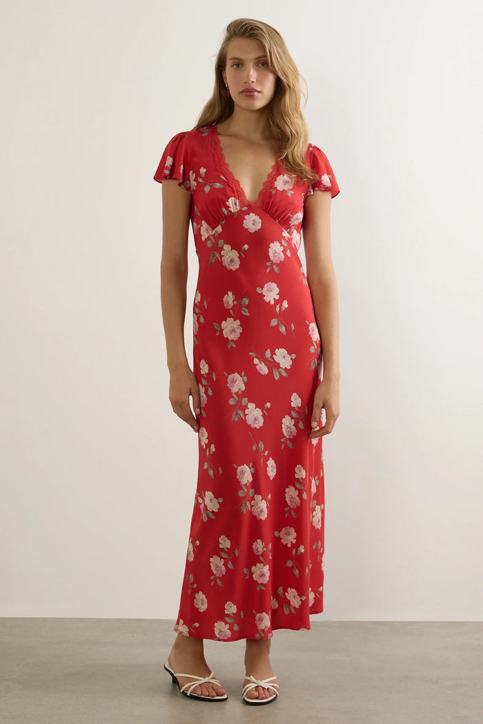 Woman wears a red floral maxi dress