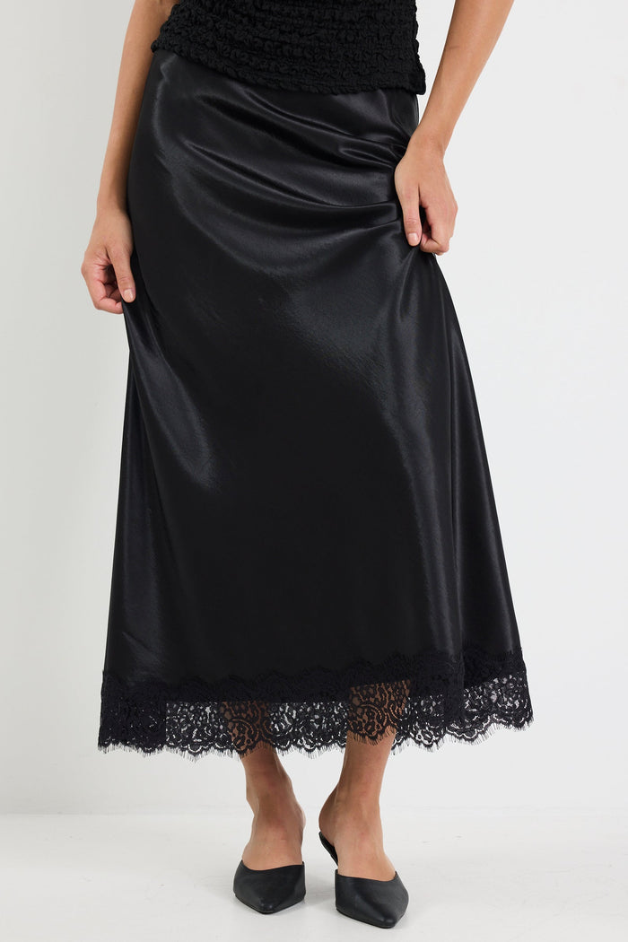 Black satin skirt with lace hem on a white background
col_pattern
