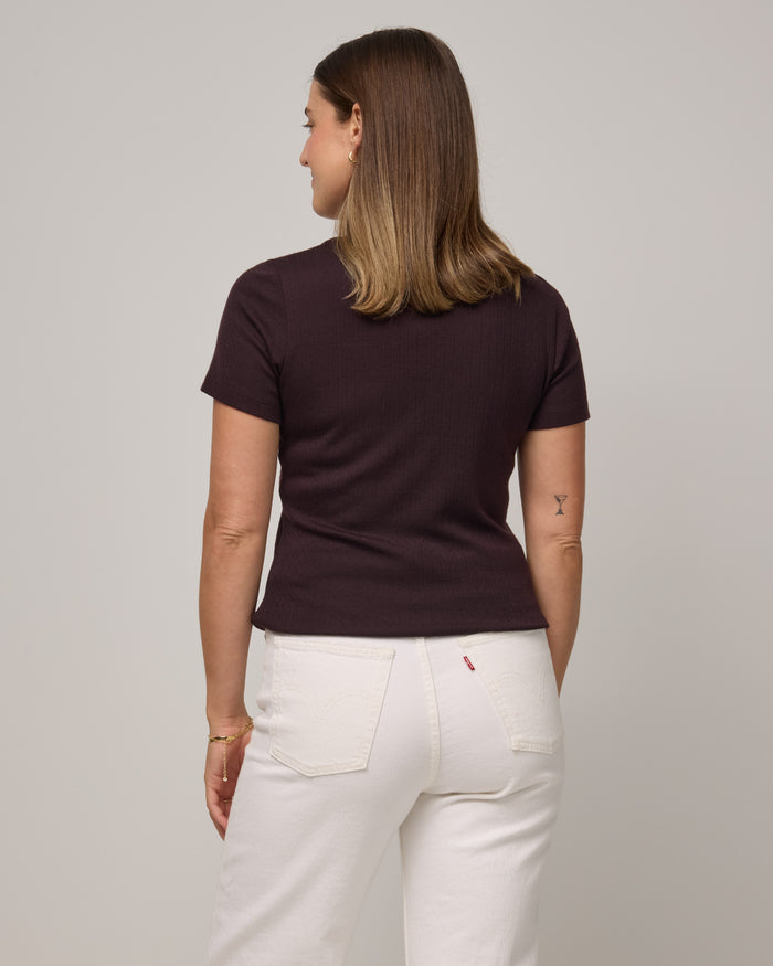 Model wearing Marie Pointelle Henley in Espresso, a dark brown color. Marie Pointelle Henley is a short sleeve, scoop neck, fitted top available in sizes XS-3X.