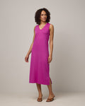 Model wearing Milena Shift Dress in Petunia, a bright fuchsia pink-purple color. Milena Shift Dress is a merino wool sleeveless, v-neck, midi shift dress available in sizes XS-3X regular, XS-XL petite.