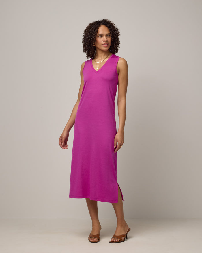 Model wearing Milena Shift Dress in Petunia, a bright fuchsia pink-purple color. Milena Shift Dress is a merino wool sleeveless, v-neck, midi shift dress available in sizes XS-3X regular, XS-XL petite.