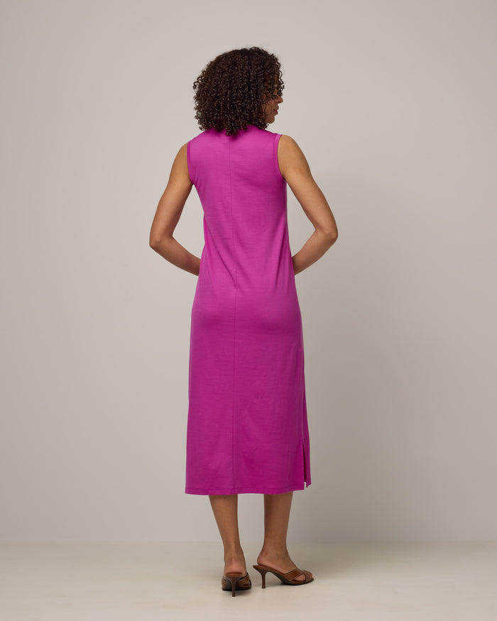 Model wearing Milena Shift Dress in Petunia, a bright fuchsia pink-purple color. Milena Shift Dress is a merino wool sleeveless, v-neck, midi shift dress available in sizes XS-3X regular, XS-XL petite.