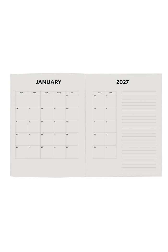 An open monthly calendar spread showing January 2027, with a grid calendar on the left page and lined writing space on the right page, photographed on a plain white background.
