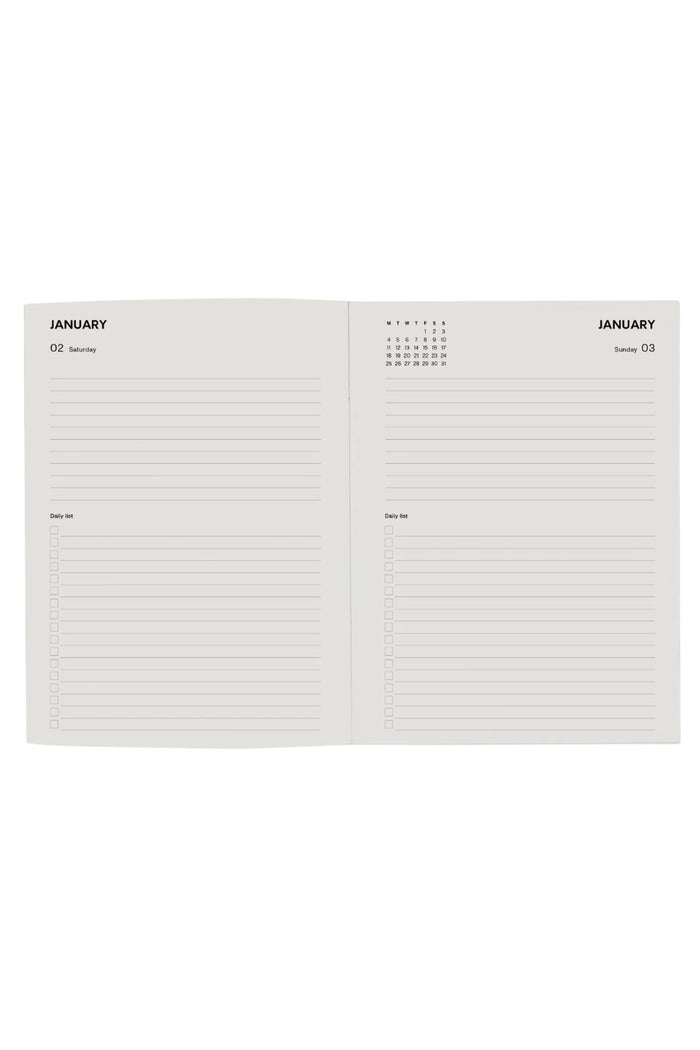 An open planner or notebook showing two blank lined pages for January, with a small calendar grid at the top of each page, photographed on a plain white background.