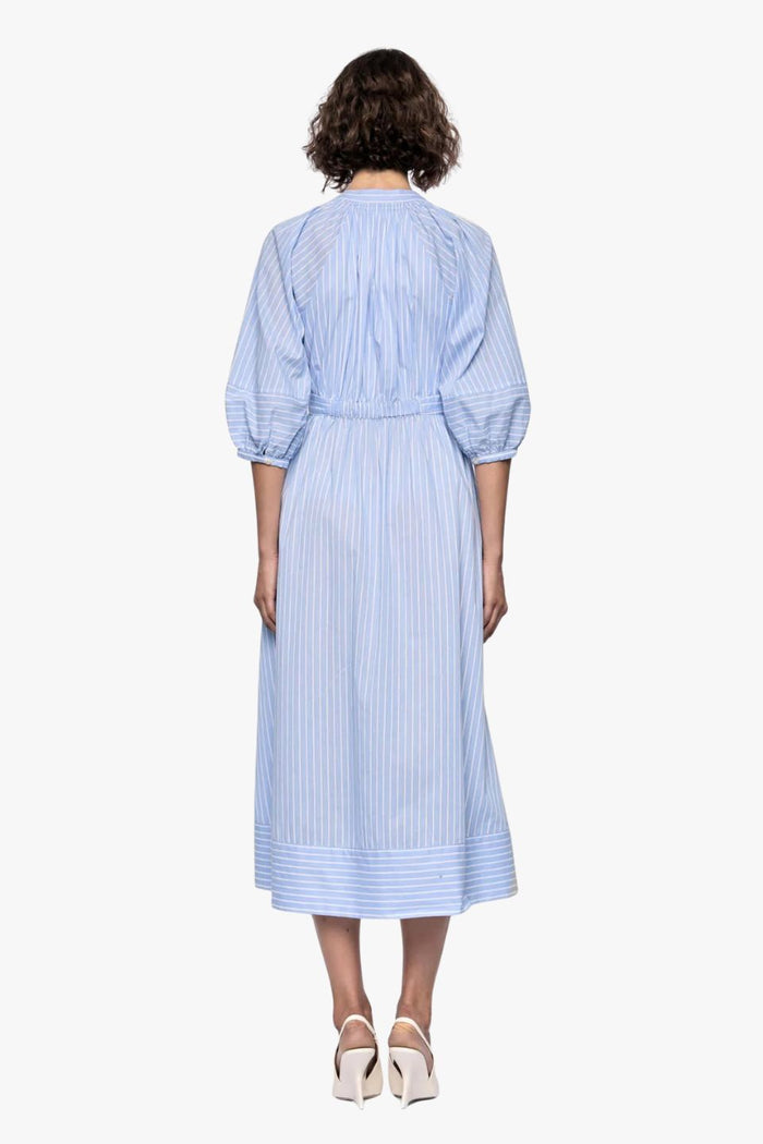 woman wearing a blue and white striped midi shirt dress
