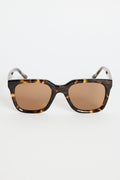 Rounded-square tortoiseshell sunglasses with warm brown tinted lenses, photographed on a white background