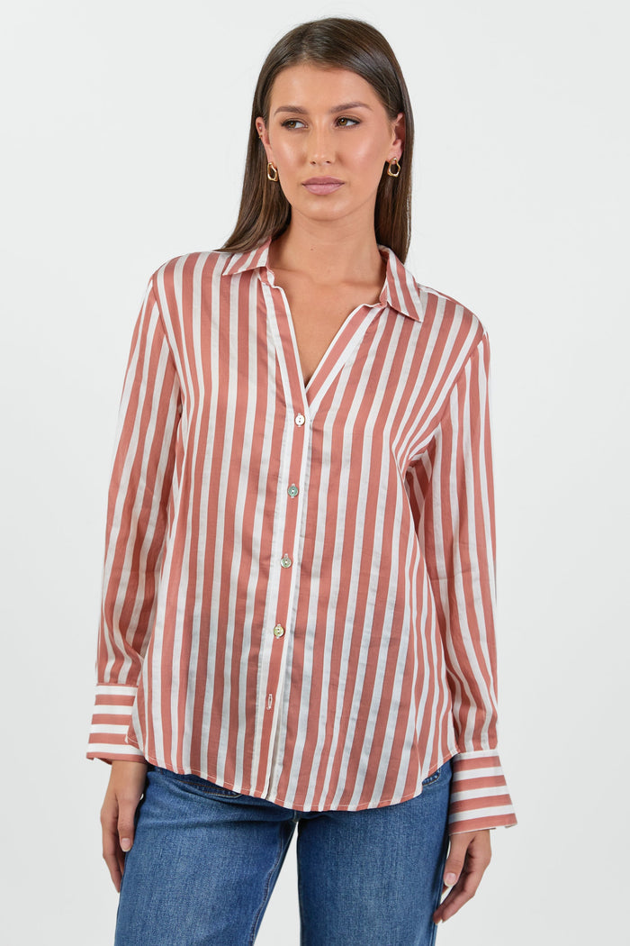 Woman wearing a red and white striped shirt with blue jeans on a white background