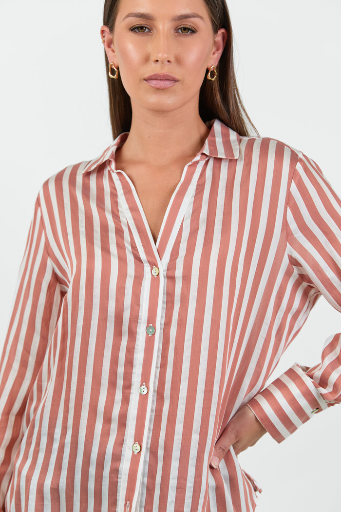 Woman wearing a red and white striped shirt on a plain background