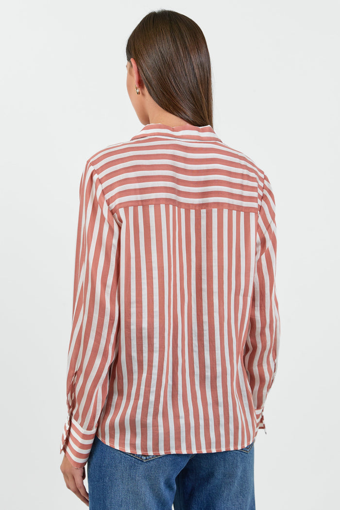 Person wearing a red and white striped shirt on a plain background