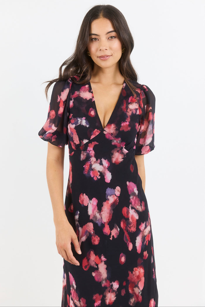 Woman wearing a floral dress on a white background