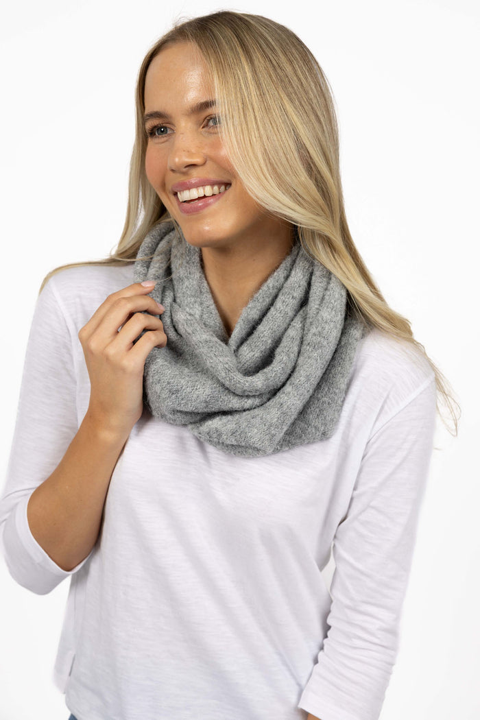 Woman wearing a gray scarf on a white background