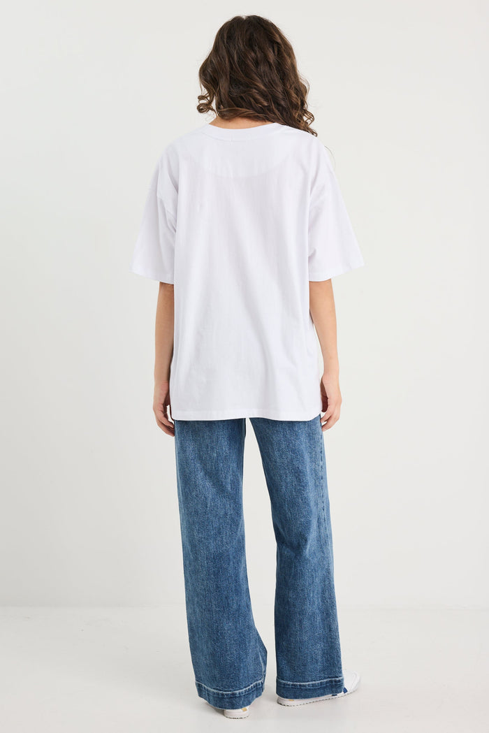 Person wearing a white top and blue jeans on a white background