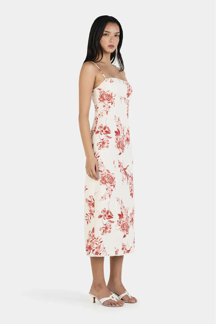 Woman wearing a white floral dress on a white background