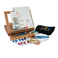 Art supply set with paint tubes, brushes, and an easel on a white background