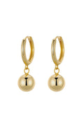 Gold hoop earrings with round dangling beads on a white background